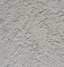 Close-up of a light gray stucco wall texture, ideal for backgrounds.